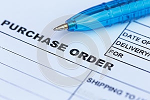 Purchase order with blue pen in the officeâ€